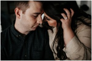 Couple with heads together and engagement ring
