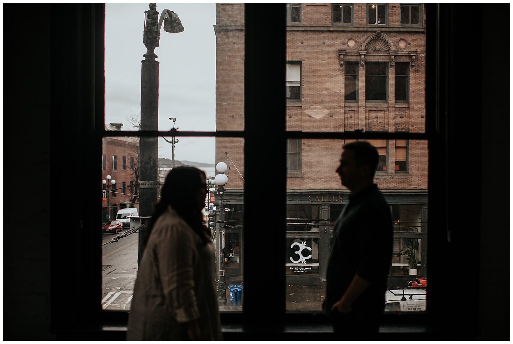 couple in front of city window