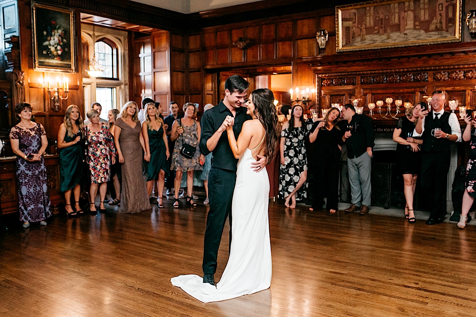Summer wedding at Thornewood Castle: bride and groom have first dance at reception.