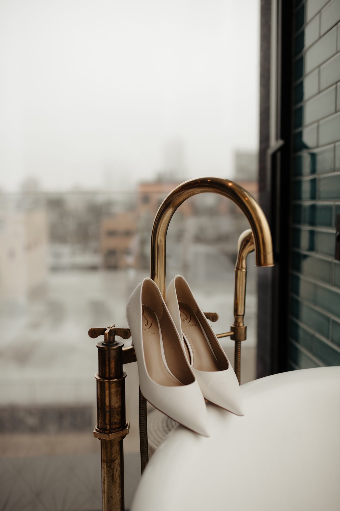 Bridal heels on a brass faucet at the Arlo Williamsburg before an Aurora Brooklyn wedding | New York wedding photographer Tonie Christine