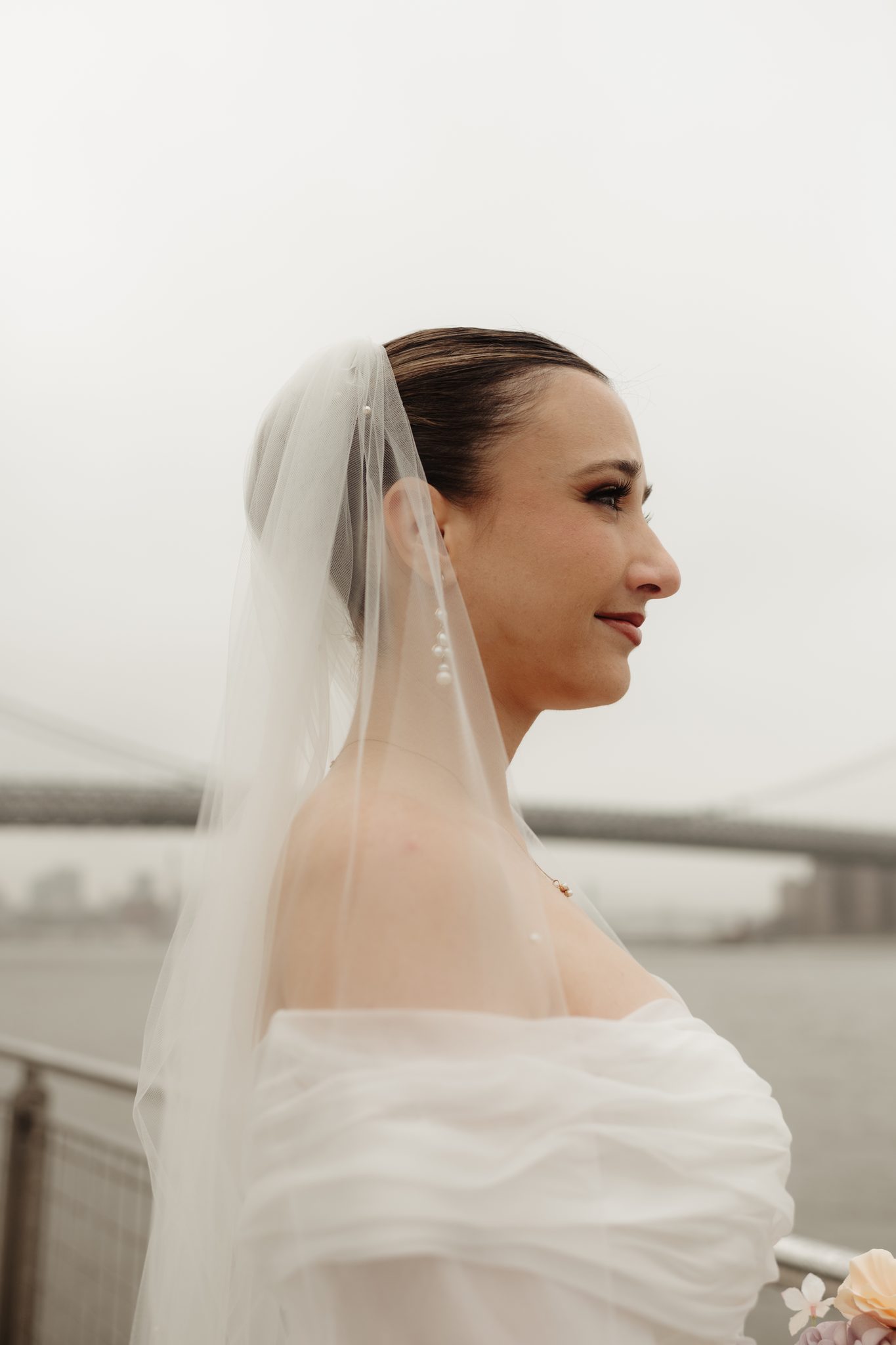 Bridal portrait in profile with the Williamsburg Bridge behind her, Brooklyn NYC wedding | New York wedding photographer Tonie Christine
