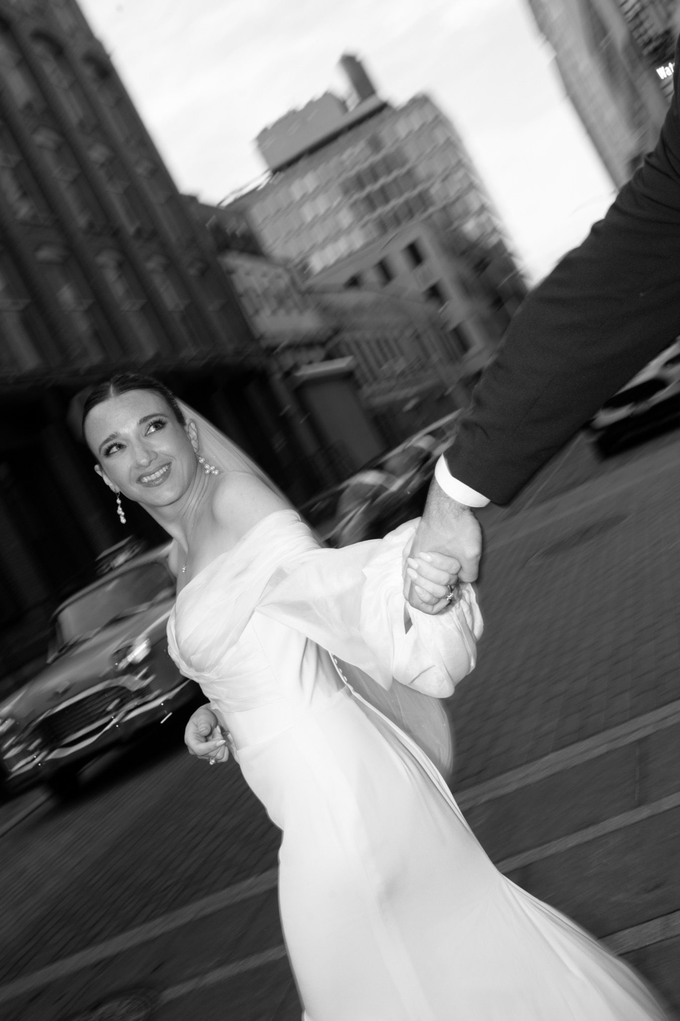 Black and white editorial of the bride twirling on a Brooklyn street, NYC | New York wedding photographer Tonie Christine