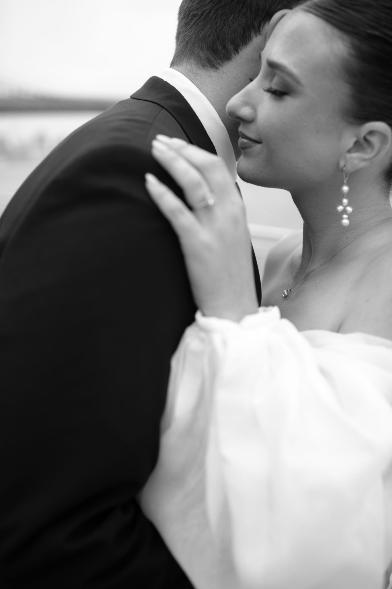 Black and white romantic portrait of the bride and groom embracing in Brooklyn, NYC | New York wedding photographer Tonie Christine