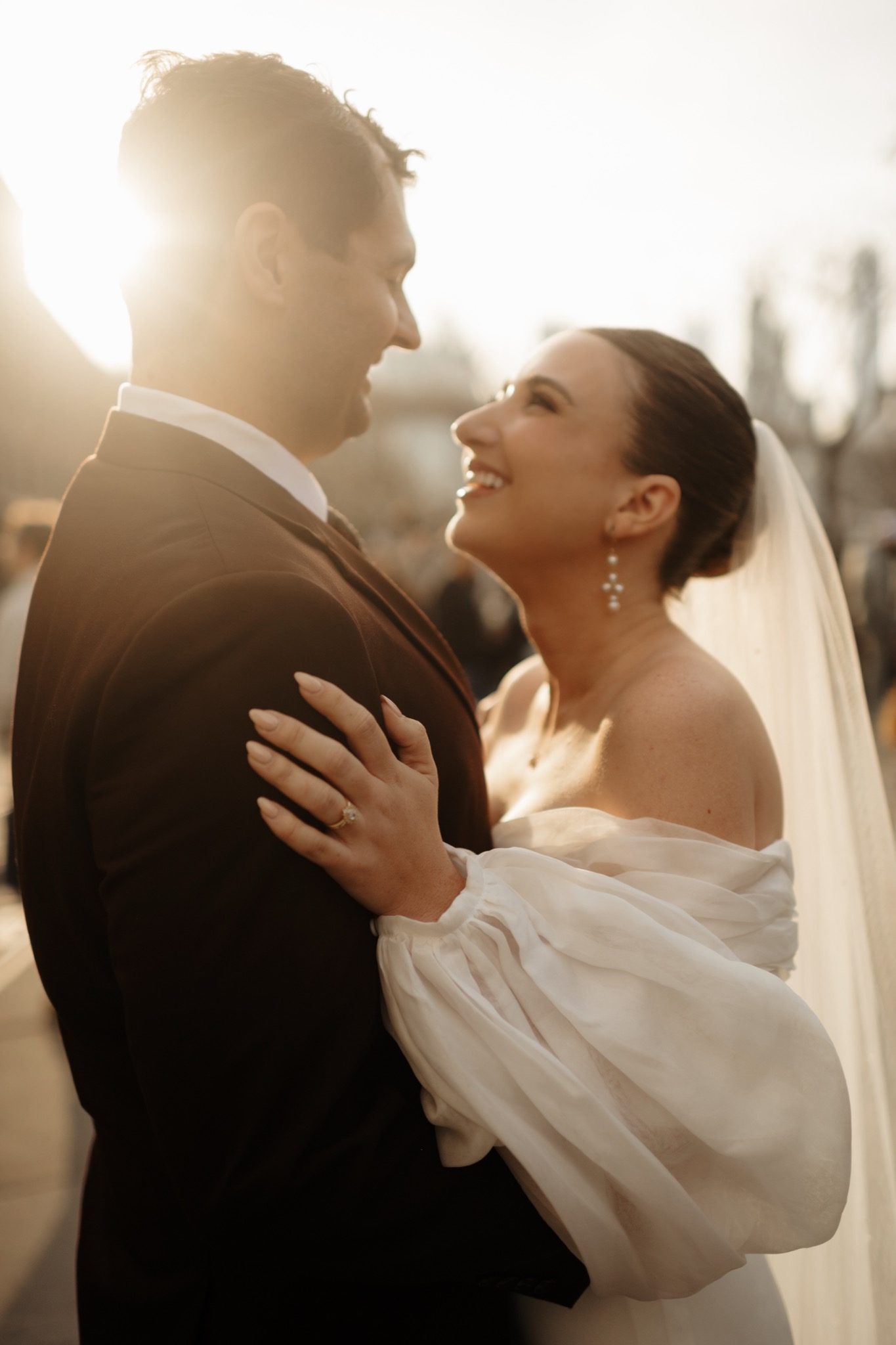 Bride and groom embracing in golden hour light in Brooklyn after their Aurora Brooklyn wedding | New York wedding photographer Tonie Christine