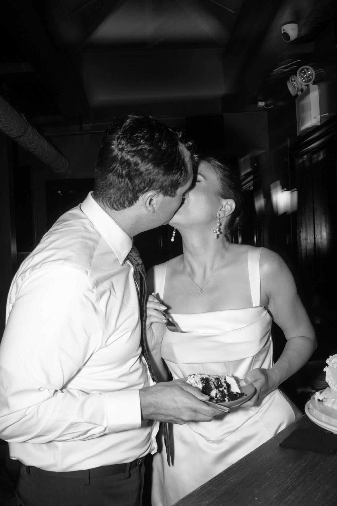 Black and white of the bride and groom kissing at the Madeline's after party in Greenpoint, Brooklyn | New York wedding photographer Tonie Christine
