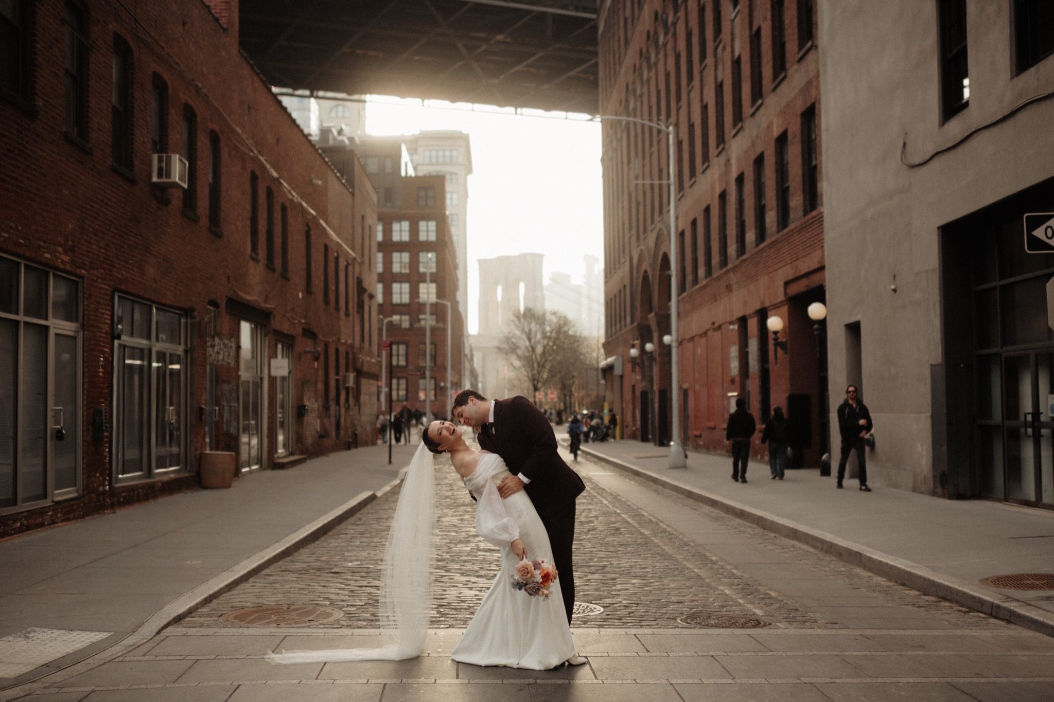 Bride and groom in the middle of a DUMBO street at golden hour, Brooklyn NYC | New York wedding photographer Tonie Christine