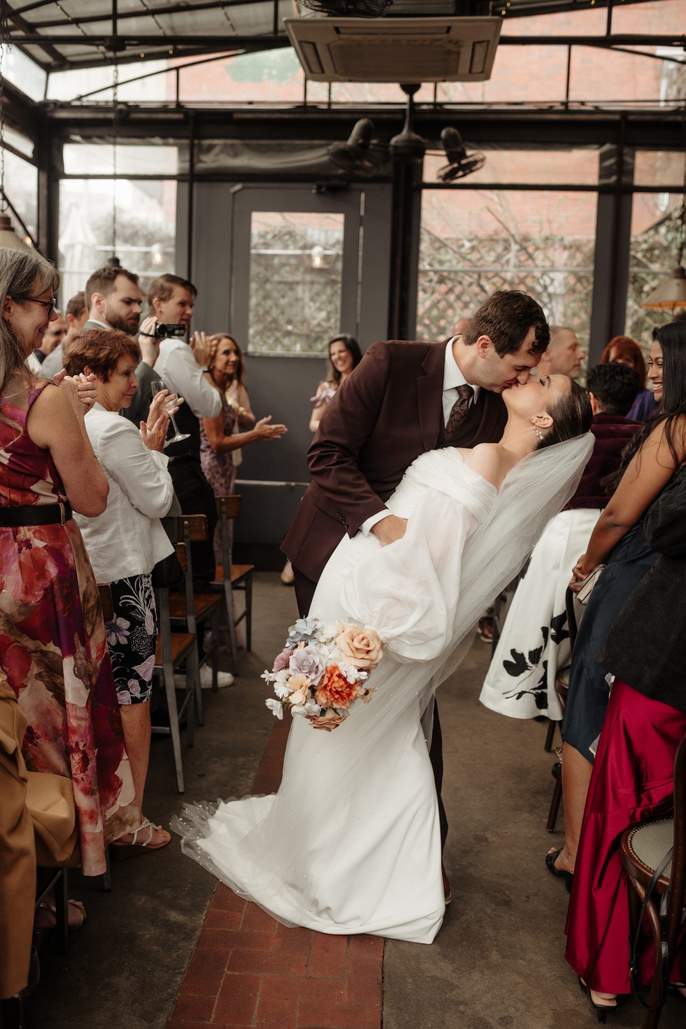 Groom dips the bride for a kiss down the aisle at Aurora Brooklyn, NYC | New York wedding photographer Tonie Christine
