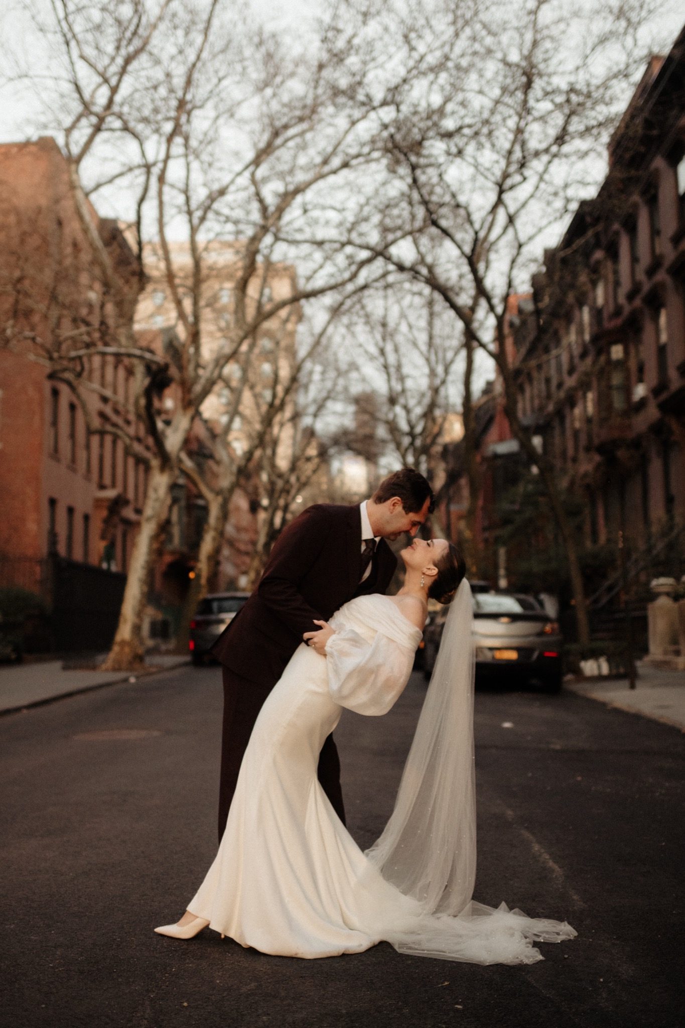 Dip kiss on a tree-lined brownstone street in Brooklyn, NYC | New York wedding photographer Tonie Christine