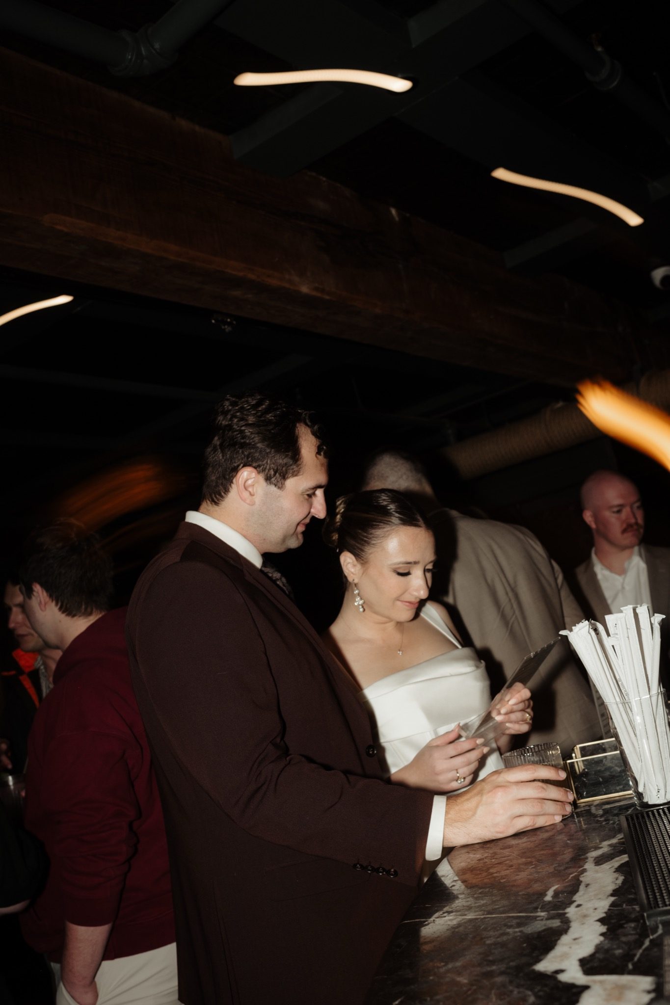 Bride and groom with guests at the after party at Madeline's in Greenpoint, Brooklyn NYC | New York wedding photographer Tonie Christine