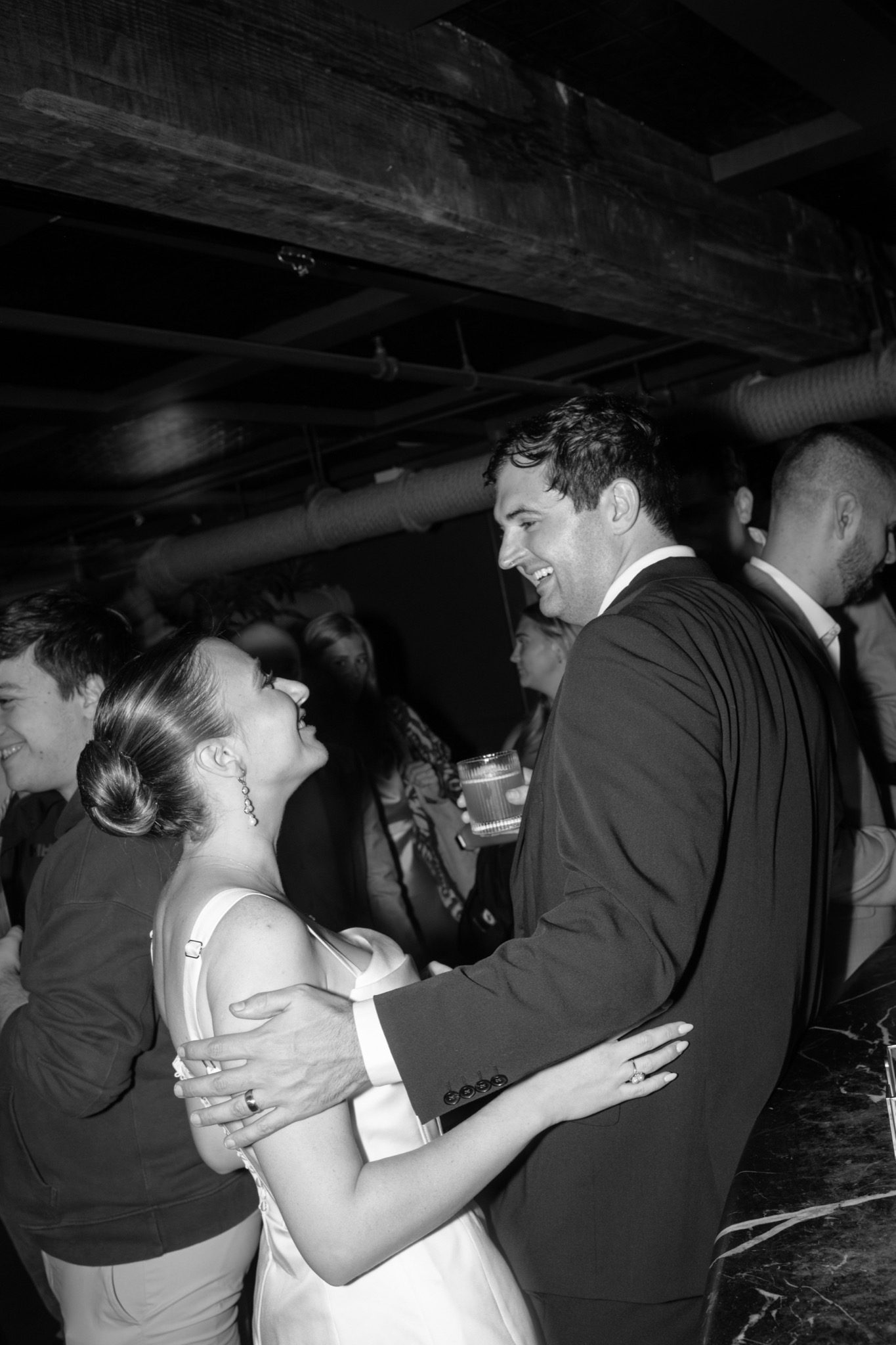 Black and white candid of the couple at their after party at Madeline's in Greenpoint, Brooklyn | New York wedding photographer Tonie Christine