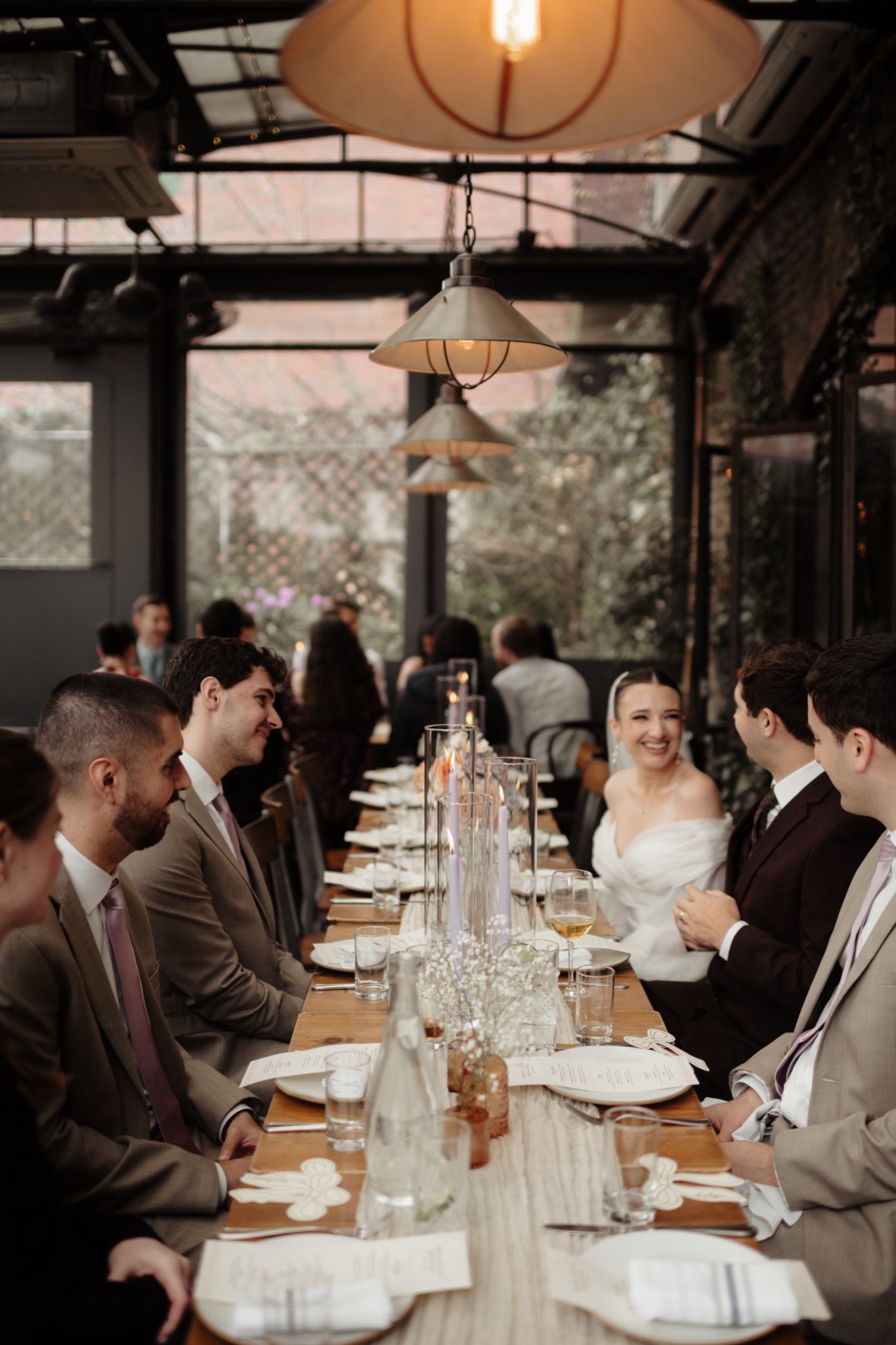 Guests at the long family-style reception table at Aurora Brooklyn, Williamsburg NYC | New York wedding photographer Tonie Christine