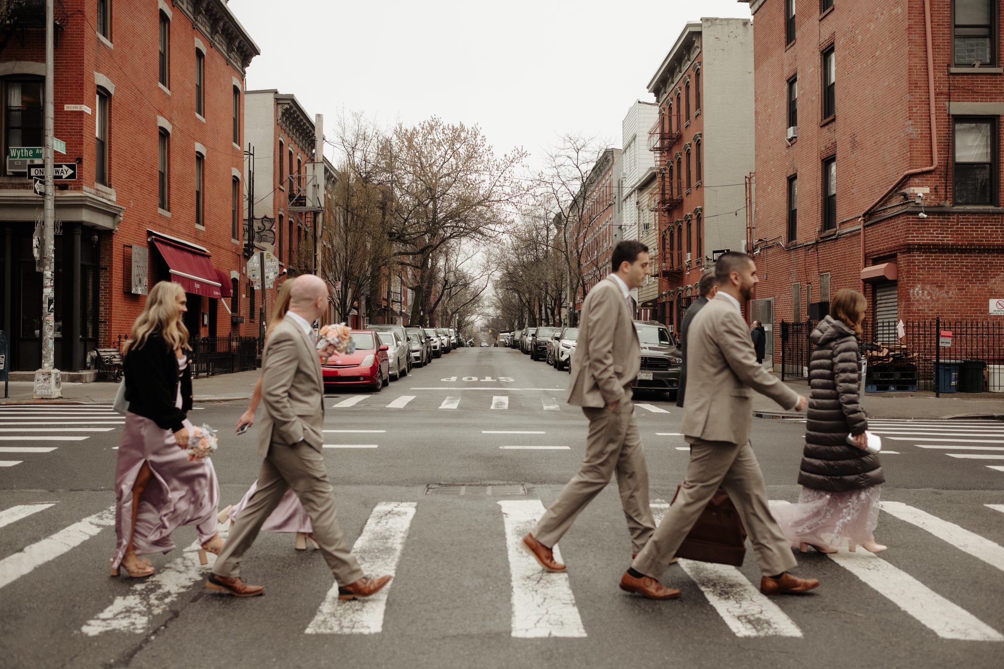 Wedding party crossing Wythe Avenue in Williamsburg, Brooklyn on the way to Aurora Brooklyn | New York wedding photographer Tonie Christine